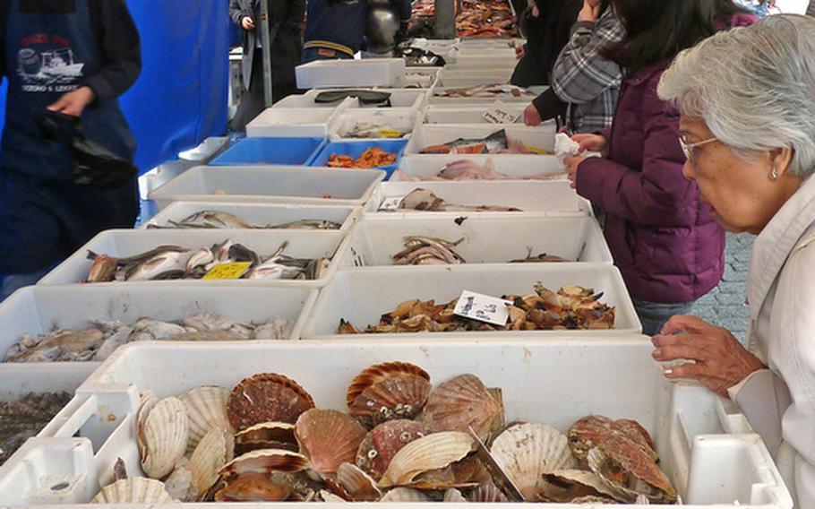 Shoppers check out the goods at a fish stand on market day in ?s Hertogenbosch, Netherlands.