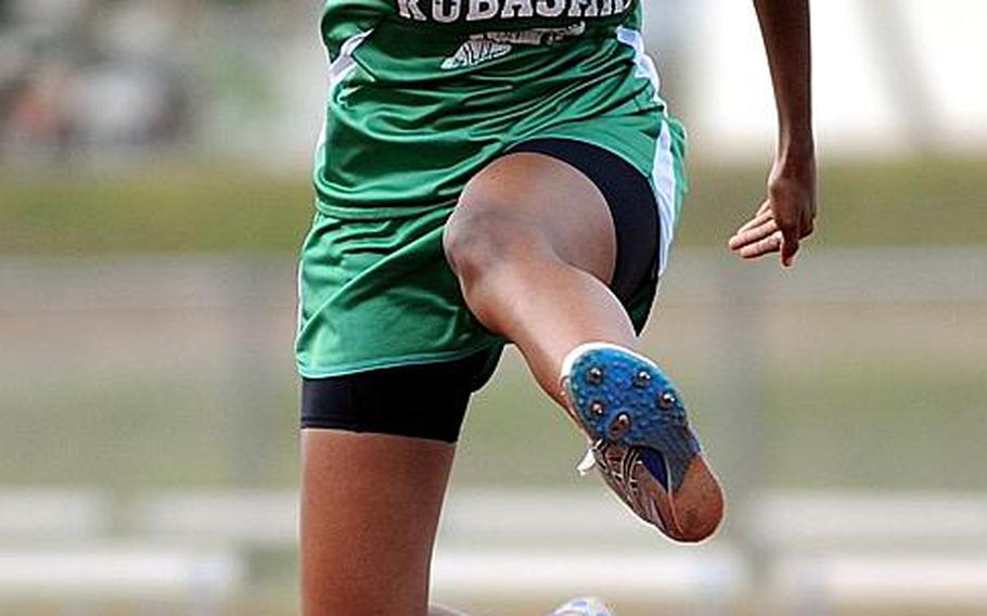 Kubasaki's Milyka Dees leaps the last hurdle in the 300-meter hurdles event during Friday's field events in the Okinawa Activities Council weekly quadrangular track and field meet at Kubasaki High School, Okinawa. Dees won the event in 51.14 seconds and also won the 100 hurdles and long jump.