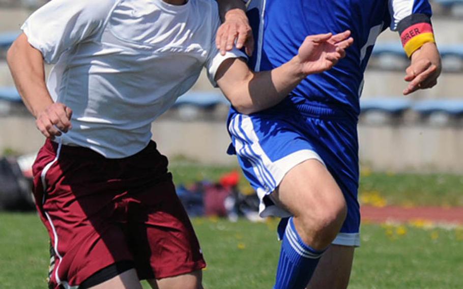 Baumholder's Ryan Edwards, left, and Ramstein's Jonathan McLouth battle for the ball in a game at Baumholder on Saturday. McLouth scored a goal in Ramstein's 5-1 win, in what had been a defensive battle until the Royals scored three goals late.