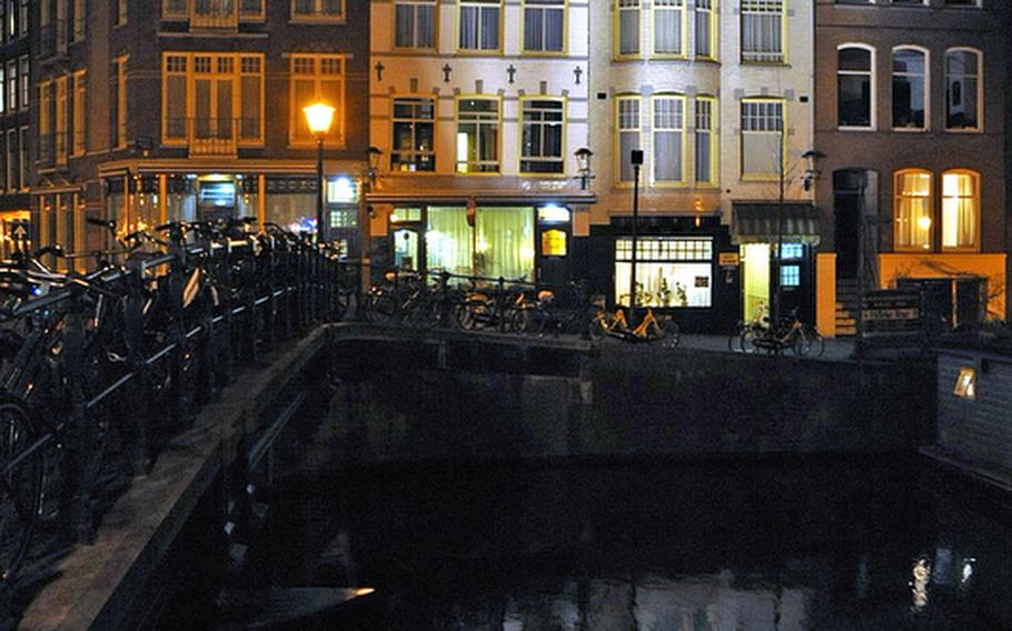 Amsterdam canal houses line, and are reflected in, the Prinsengracht.