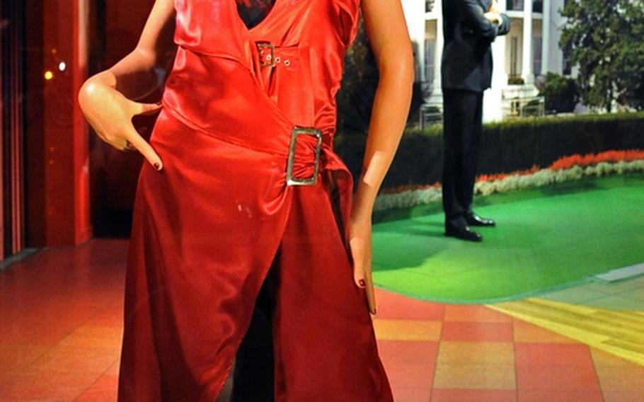 A wax Kylie Minogue, dressed appropriately for the Amsterdam night life, and President Barack Obama welcome visitors to the city's branch of Madame Tussauds.