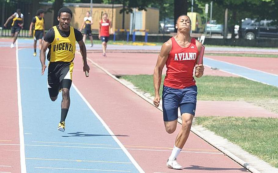 Aviano's Dan Bert beats Vicenza's Tieron Sanders to the finish line in the 4x100 meter relay race, but the Saints were eventually disqualified, giving the Cougars the victory in 46.9 seconds. Bert had won the 100 earlier in a time of 11.1.