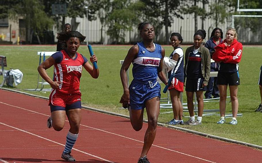 Ramstein's Kristiana Jones edges out Lakenheath's Shaionica Speight in the last leg of the 4x100 meter relay at RAF Lakenheath, England. Ramstein finished in 53.81 seconds, Lakenheath in 53.97. Both teams had already qualified for the track and field championships this week.