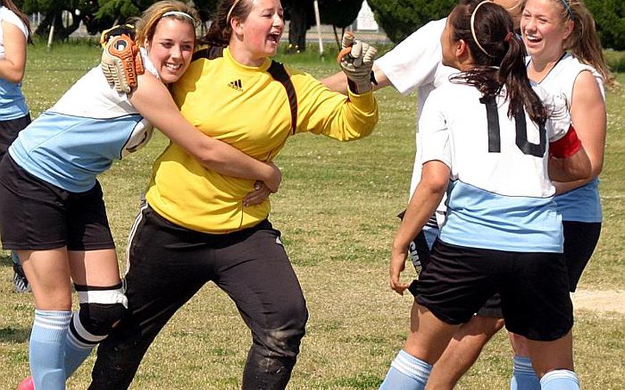 Osan American players, led by goalkeeper Deanne Polaski, celebrate after their penalty-kick shootout victory over Daegu American in the 2011 Far East High School Girls Division II Soccer Tournament double-elimination playoffs at Marine Corps Air Station Iwakuni, Japan.