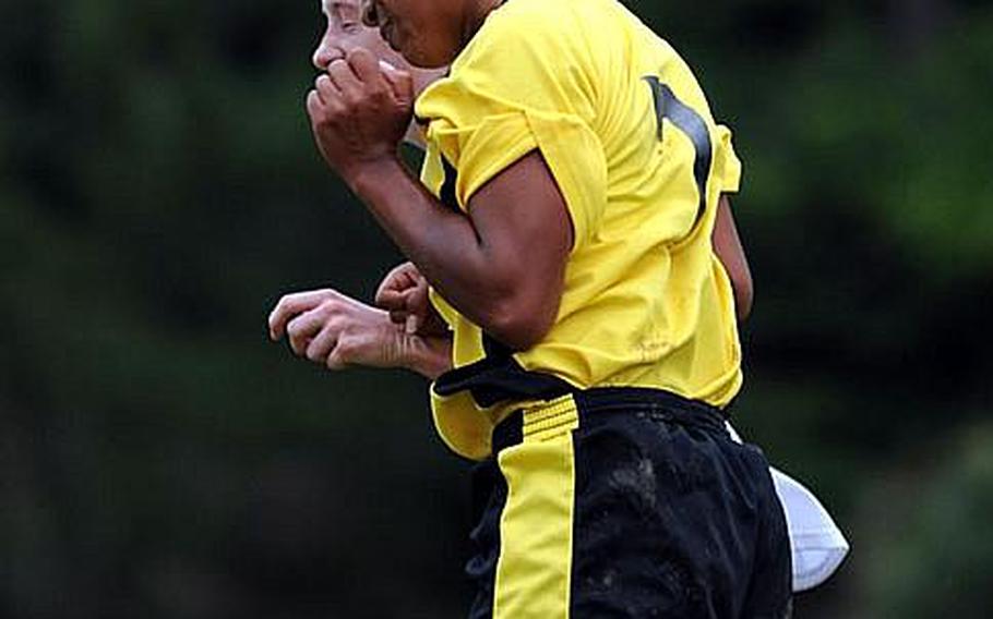 Kadena's Symone Sison-Johnson heads the ball next to Julie Keese of American School In Japan during Wednesday's quarterfinal match in the 2011 Far East High School Girls Division I Soccer Tournament at Kadena Air Base, Okinawa. ASIJ edged Kadena, 2-1.