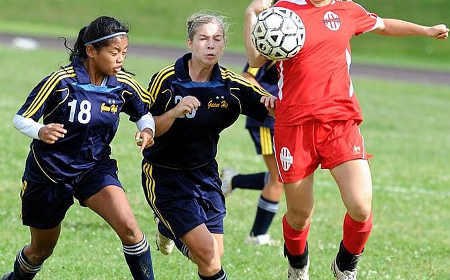 Nile C. Kinnick's Kaile Johnson, right, tries to settle the ball as Guam High's Martina Duenas, left,and Britanie Bing give chase during Wednesday's quarterfinal match in the 2011 Far East High School Girls Division I Soccer Tournament at Kadena Air Base, Okinawa. The Red Devils rallied from a 1-0 halftime deficit to beat the Panthers, 3-1.