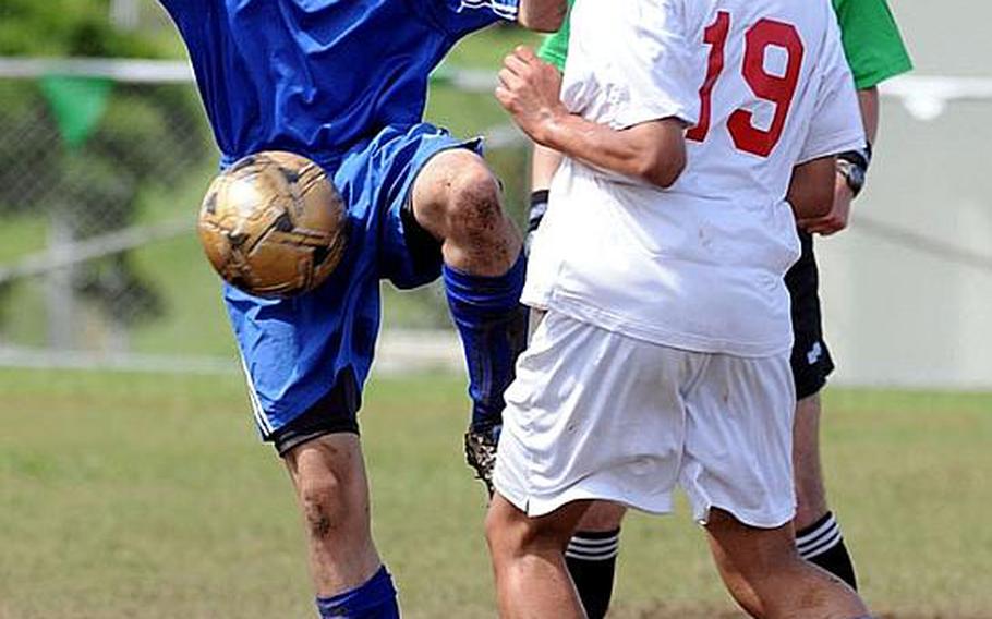 Yokota's Andrew Weeks tries to settle the ball in front of Dustin Wilson during Wednesday's quarterfinal match in the 2011 Far East High School Boys Division I Soccer Tournament at Camp Foster, Okinawa. The Red Devils shut out the Panthers, 5-0.