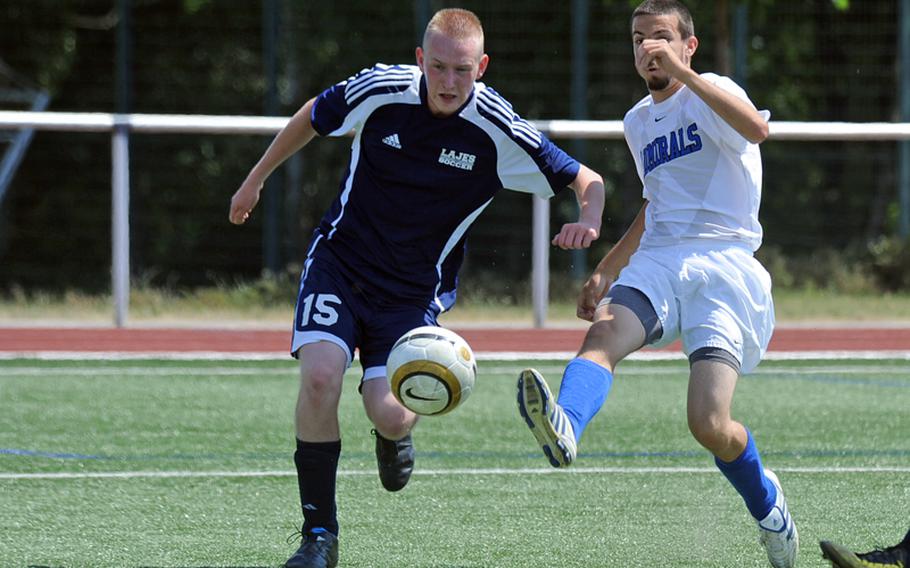 Rota's Carlos Shay, right, shoots on goal against Jeff Goodson of Lajes in a Division III game on opening day of the DODDS-Europe soccer championships on Wednesday. Shay had two goals in the Admirals' 3-0 win.