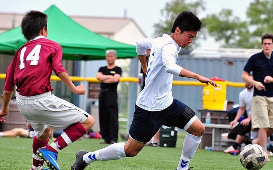 Yongsan International-Seoul's Jona Park dashes past Matthew C. Perry's Dan Holmes with the ball during Thursday's championship match in the 2011 Far East High School Boys Division II Soccer Tournament at Camp Humphreys, South Korea. YIS-Seoul won its third D-II Tournament title in four years, blanking Perry, 4-0.