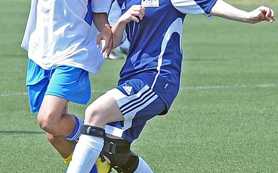 Incirlik can call itself the European champion of co-ed teams after defeating the other co-ed team at the DODDS-Europe tourney, Lajes, 3-0. Here  Lajes'  Alex Ciranni, right, battles Incirlik's Aaron Whitaker for the ball.