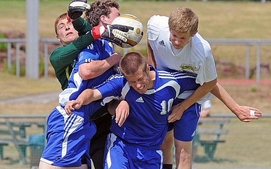 Brussels keeper Danny Helbling, left, gets his glove on the ball and, with the help of teammates Ryan Bottesini and Sam Bigelow, keep Sigonella's Jack Wegman from scoring. Sigonella beat Brussels 2-1 on Thursday.