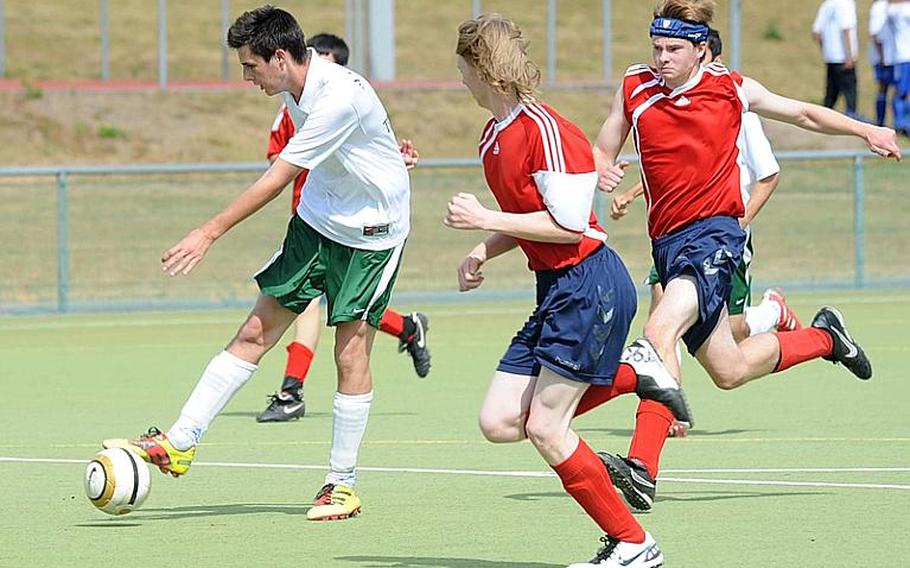 Ankara's Pablo Marin, left, beats Menwith Hill's Adam Lyons and Jacob Hurren to score the game-deciding 1-0 goal against the Mustangs in a Division III game Thursday.