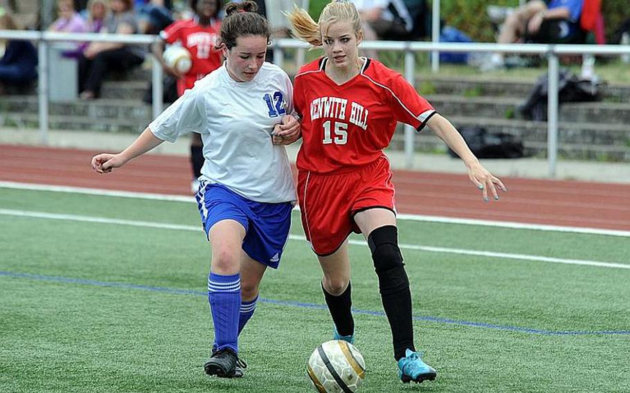 Patricia Rudy of Brussels, left, and Menwith Hill's Alex Furrow battle for the ball in a Division III match that ended 1-1 on Thursday.