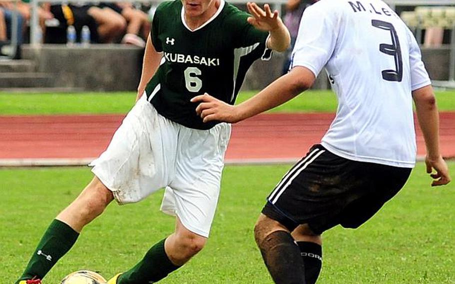 Kubasaki's Jon Goddard tries to dribble past Mitchell Lee of Seoul American during Friday's championship match in the 2011 Far East High School Boys Division I Soccer Tournament at Camp Foster, Okinawa. The visiting Falcons edged the Dragons, 1-0, in double-overtime.