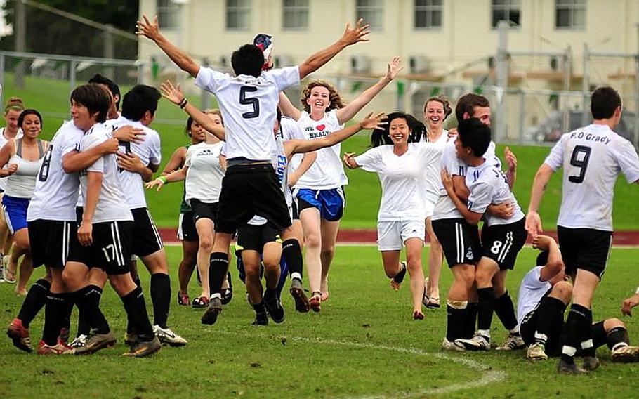 Seoul American's boys celebrate with their girls counterparts after Friday's championship match in the 2011 Far East High School Boys Division I Soccer Tournament at Camp Foster, Okinawa. The visiting Falcons edged the Kubasaki Dragons, 1-0, in double-overtime for the first boys soccer title in school history. Seoul American's girls, who won their tournament last year on the same field, finished third.