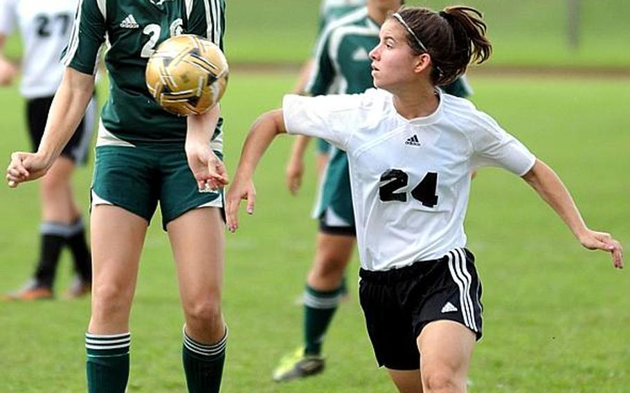 Kubasaki's Elizabeth Fabila tries to settle the ball as American School In Japan's Christin Florensie watches during Friday's championship match in the 2011 Far East High School Girls Division I Soccer Tournament at Camp Foster, Okinawa. The visiting Mustangs edged the host Dragons, 1-0, for the second title in ASIJ school history.