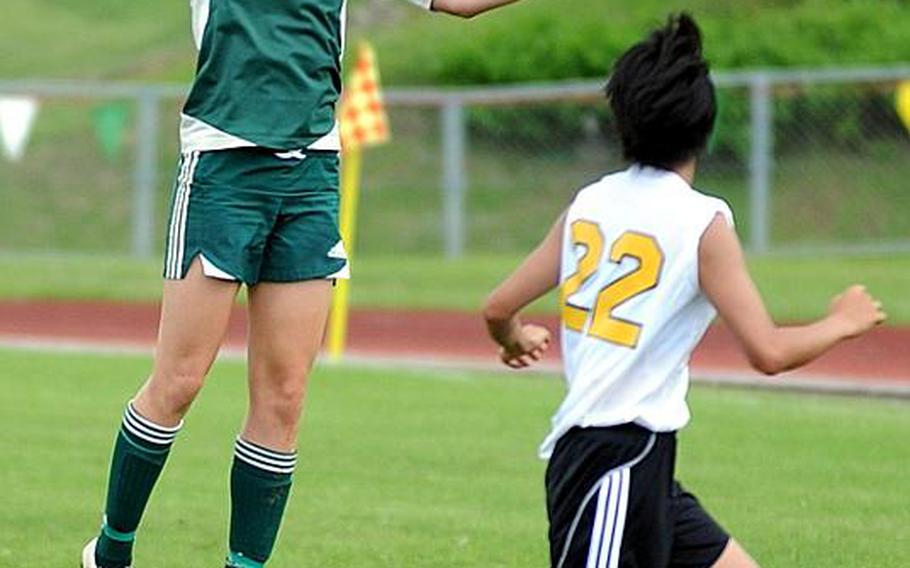 Kubasaki's Elizabeth Fabila heads the ball in front of Joey Yamada of American School In Japan during Friday's championship match in the 2011 Far East High School Girls Division I Soccer Tournament at Camp Foster, Okinawa. The visiting Mustangs edged the host Dragons, 1-0, for the second title in ASIJ school history.