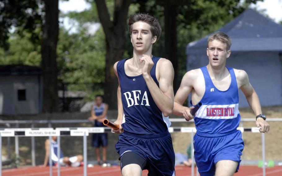 Black Forest Academy sophomore Ben Kronk tries to hold off Ramstein senior Spencer Gillespie during the second leg of the boys 4x800 meter relay at the 2011 DODDS-Europe Track and Field Championships in Russelsheim, Germany.  Black Forest Academy's time of 8 minutes, 9.56 not only earned first place in the event, but  also broke a DODDS-Europe record.