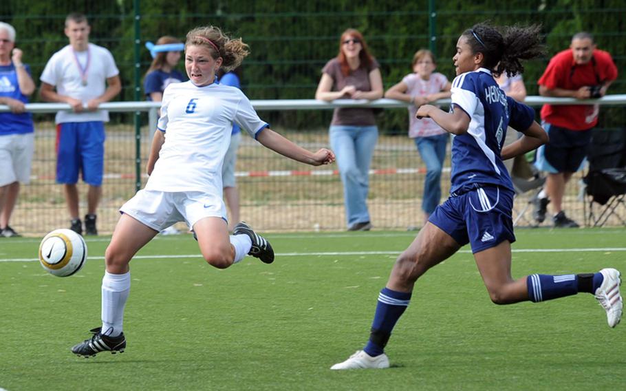 After slipping past Heidelberg's Taylor Morgan, right, Ramstein's Kaleen Carter times a volley shot on a cross from a teammate. Ramstein beat Heidelberg, 5-0, to advance to Saturday's Division I final.