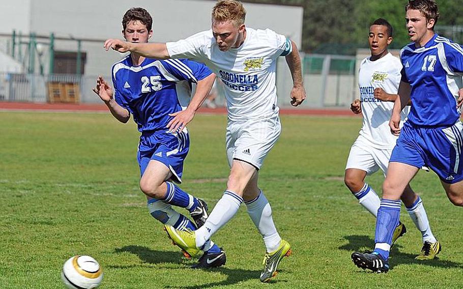 Sigonella's Ben Jacks gets past Ryan Bottesini, left, and Demir Husejnovic on his way to scoring the first goal in the Jaguars' 2-0 win in the DODDS-Europe Division III title game.