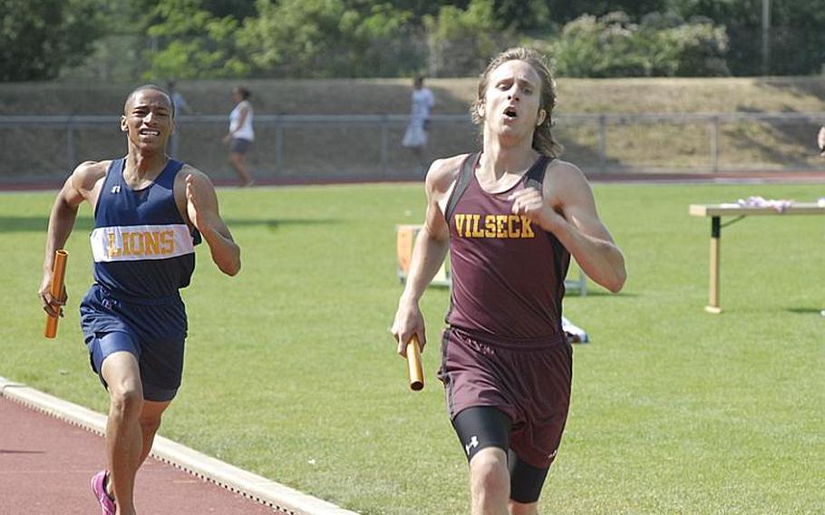 Vilseck junior David Lance holds off a hard-charging Sharaud Gallman of Heidelberg during the boys 1,600 sprint medley at the 2011 DODDS-Europe Track and Field Championships in Russelsheim, Germany. Vilseck won the relay with a time of 3 minutes, 43.01 seconds.