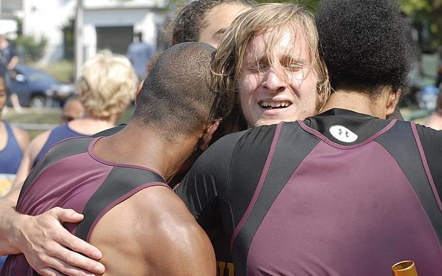 Vilseck junior David Lance gets congratulatory hugs from his teammates following the boys 1,600 sprint medley on day two of  the 2011 DODDS-Europe Track and Field Championships in Russelsheim, Germany. The team of Lance, sophomores Miles Hall and Shawn Peebles and senior Darius Whitehead won the race with a time of 3 minutes, 43.01 seconds.