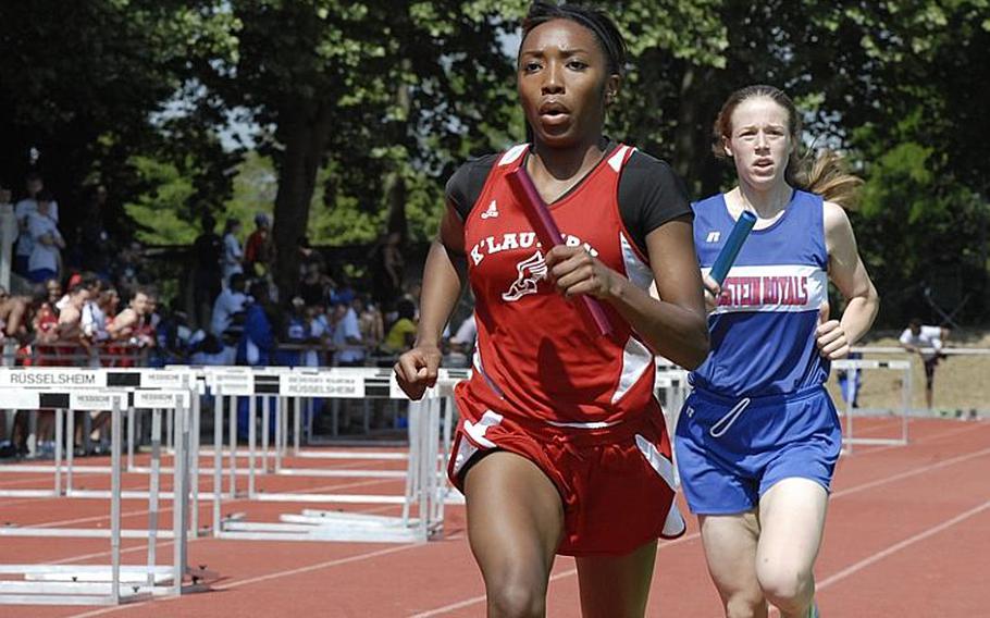 Kaiserslautern sophomore Ashley Santos holds off Ramstein junior Anna Priddy during the girls 4x800 meter relay on day two of  the 2011 DODDS-Europe Track and Field Championships.  The Kaiserlautern team of senior Colleen Davis, senior Ruby Plummer, senior Rio Harris and Santos broke a DODDS-Europe record in the event with a time of 9:55.02.