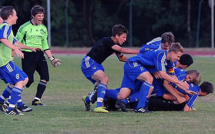 The Ramstein Royals celebrate their 2-1 win over Lakenheath in the Division I title game in Ramstein on Saturday.