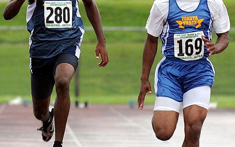 Yokota's Preston Brooks, right, gives a quick glance to his right at Patrick Bailey of Guam High in the boys 100-meter dash during Tuesday's finals of the 2011 Far East High School Track and Field Meet at Camp Foster, Okinawa. Brooks won in 11.17 seconds; Bailey finished third in 11.50.