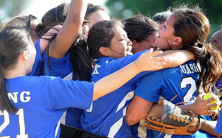 Seoul American Falcons players celebrate their 14-10, eight-inning Far East High School Girls Softball Tournament title-clinching victory over defending champion and host Kadena on Thursday at Kadena Air Base, Okinawa.