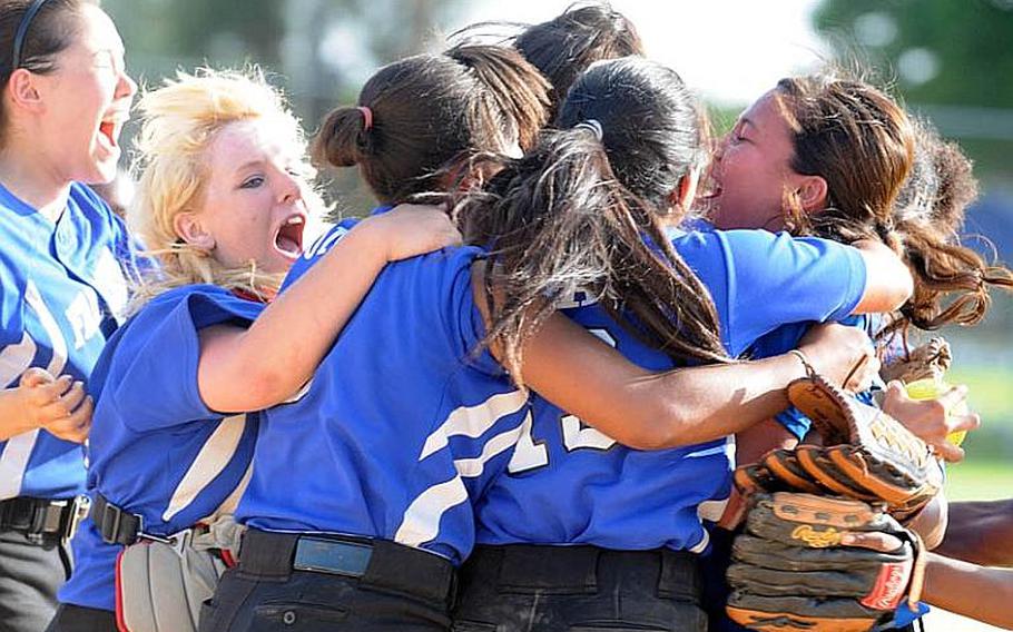 Seoul American Falcons players celebrate their 14-10, eight-inning Far East High School Girls Softball Tournament title-clinching victory over defending champion and host Kadena Thursday at Kadena Air Base, Okinawa.