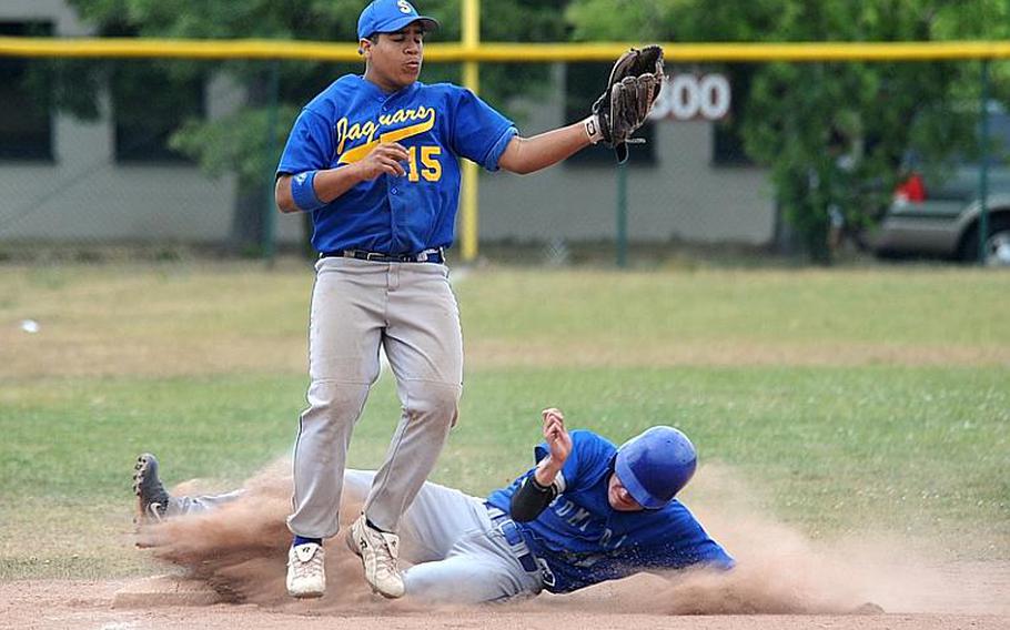 Rota's Kevin Banks slides into third as Sigonella's Franco Garcia pulls down a throw from the outfield in opening-day Division III action at the DODDS-Europe baseball championships in Ramstein on Thursday. Rota won the game. 8-6.