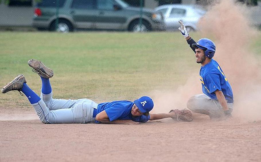 Rota's Cody Holland, left, and Sigonella's Marco Summerfield wait for the umpire's call at second. Summerfield was safe, but Rota won the Division III game, 8-6, on opening day of the DODDS-Europe baseball championship.