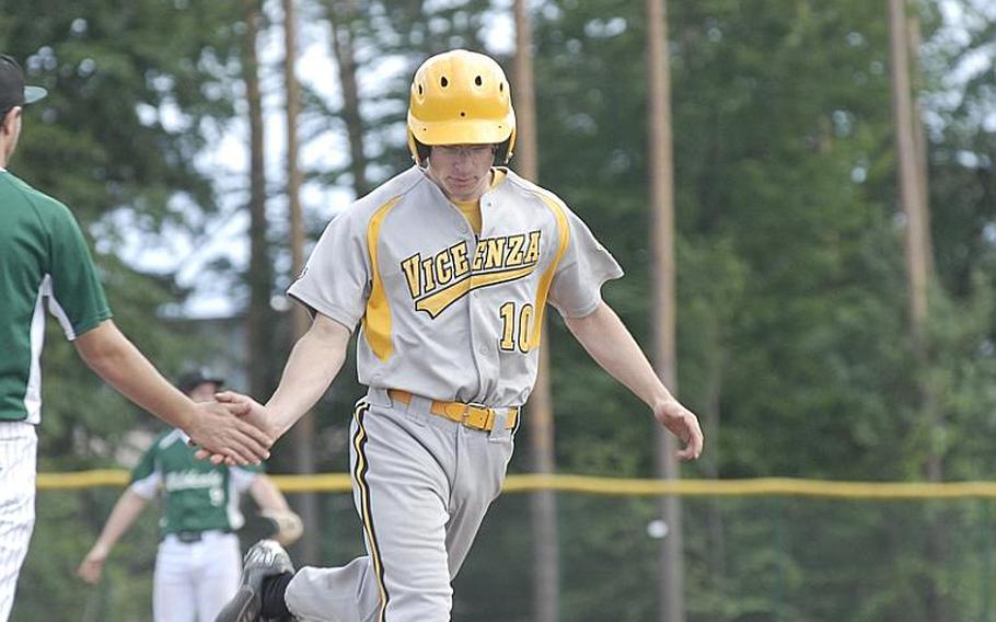 Vicenza junior Cooper Armstrong is congratulated by a Naples player after belting a two-run homerun in Friday's Division II baseball semifina.  Vicenza rallied with 10 runs in the sixth inning to win the game 14-12 and advance to Saturday's final.