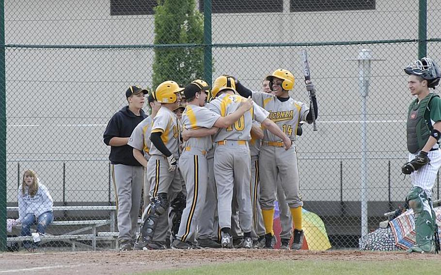 Vicenza junior Cooper Armstrong is mobbed by his teammates as he crosses home plate following a two-run homer during Friday's Division II semifinal baseball game against Naples.  Vicenza rallied with 10 runs in the sixth inning to win 14-12 and advance to Saturday's final.