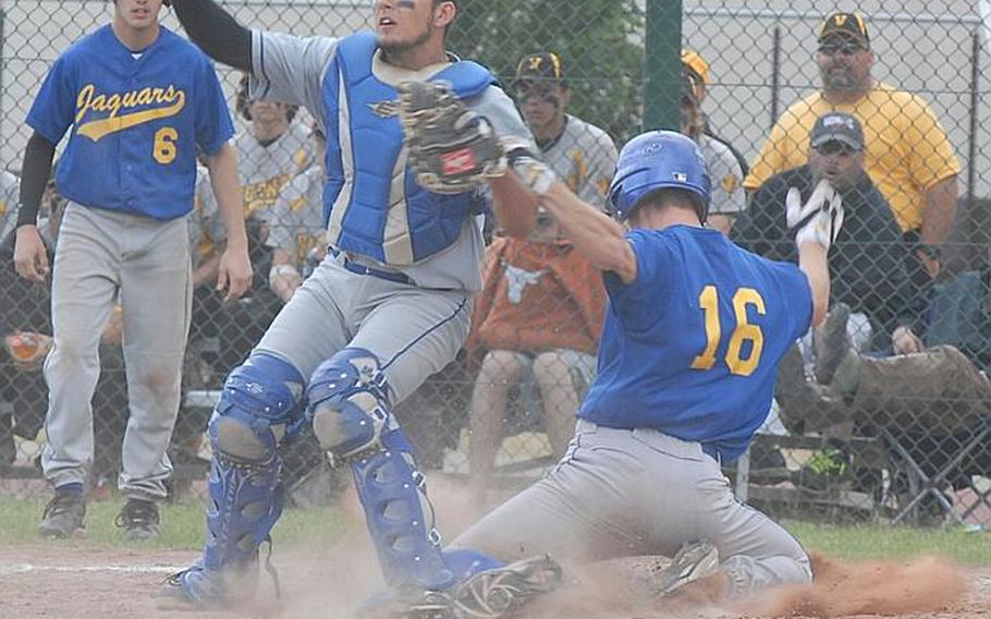 Sigonella senior Tyler Cornell slides under the reach of Rota senior catcher Gannon Soares during Saturday's Division III championship game in Ramstein, Germany.  Cornell was called out on the play for interfering with the catcher's arm during his slide.  Rota held on for the victory, 7-6.