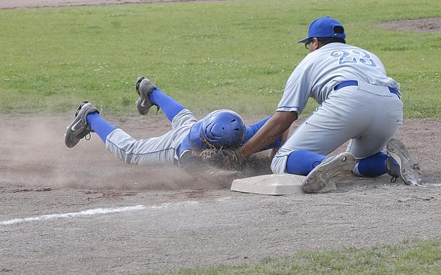 Rota junior Frankie Esquivel tags out Sigonella sophomore Chase Berryhill in a play at third base Saturday.  Rota won the game, 7-6, to capture the Division III championship.