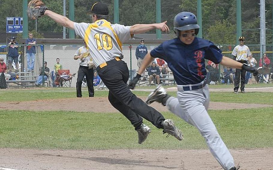 Vicenza junior Cooper Armstrong tries to reel in an errant throw the first as 
Bitburg freshman Issaac Ramon crosses the bag during the Division II baseball championship game in Ramstein, Germany.  Bitburg went on to win the game, 5-3.