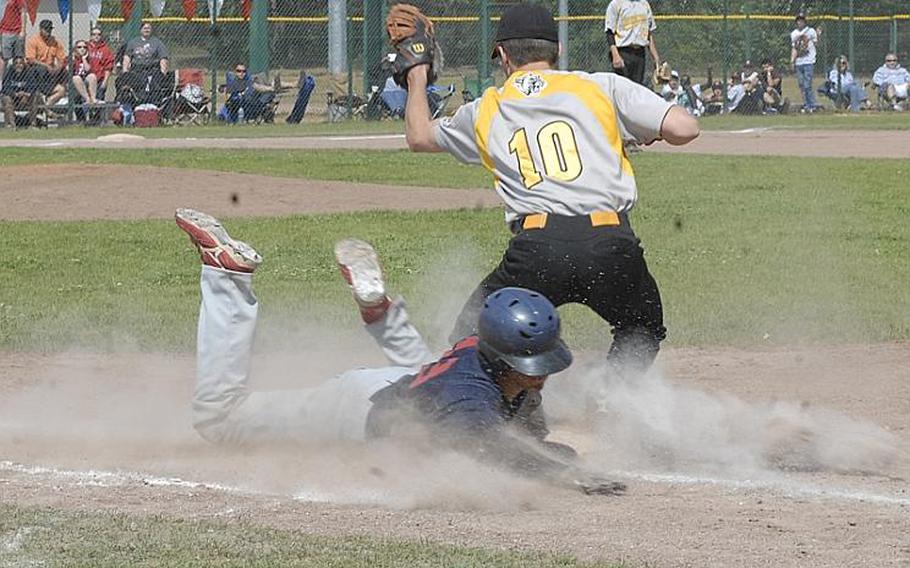 Bitburg junior Austin Schmidt slides into first base as Vicenza first-baseman Cooper Armstrong takes the throw during Saturday's Division II championship game, won by Bitburg 5-3.