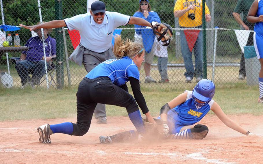 Sigonella's Mikaela Palmers scores the go-ahead run as Incirlik's Autumn Moir is late with the tag. The Jaguars beat Incirlik 13-11 for the Division III title.