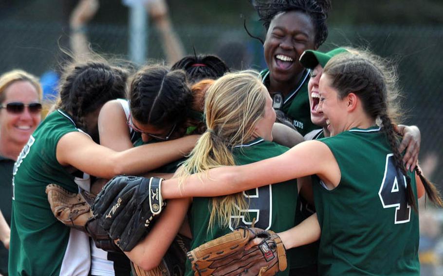 The Naples Lady Wildcats celebrate their Division II title after defeating AFNORTH 11-3 at the DODDS-Europe softball tournament.