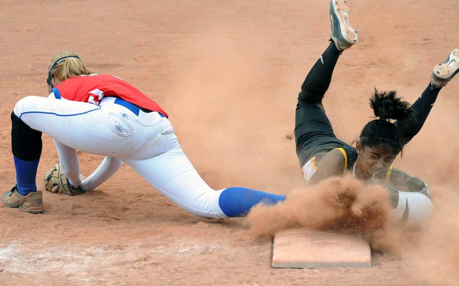 Patch's Bianca Lopez dives back safely to first after being off base when an infielder snagged a line drive. At left is Ramstein's Kathryn Enyeart. Patch beat Ramstein 8-2 for the Division I title.