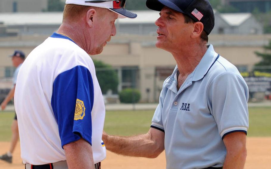 American Legion coach John O'Brien and umpire Robert Nott discuss a disagreement over a call during Monday's men's best-of-three championship series.
