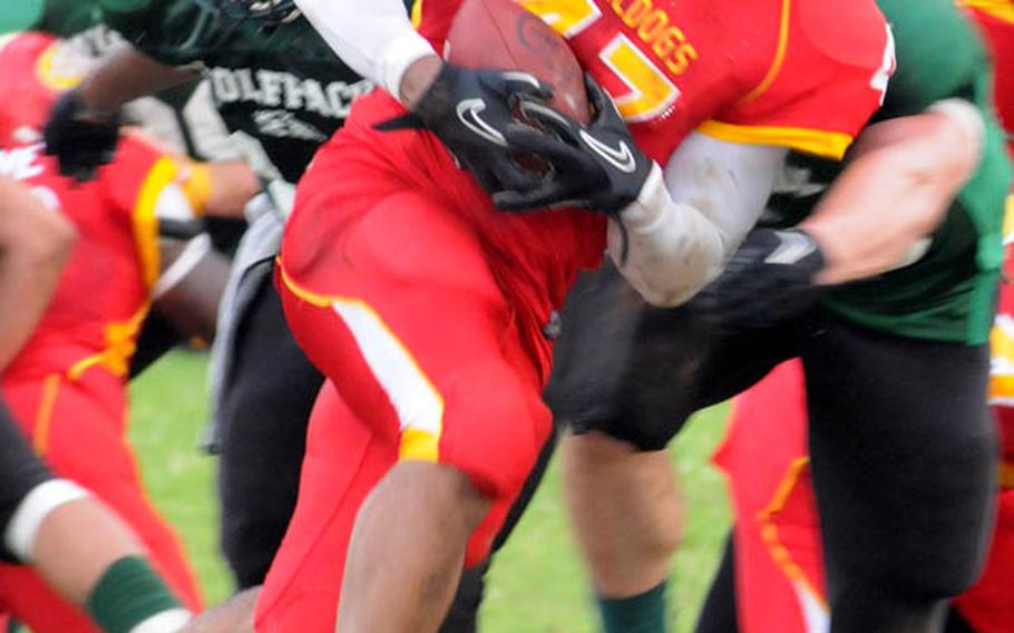 Foster Bulldogs fullback Madison Axel bulls his way through Joint Task Force Wolfpack defenders during Saturday's U.S. Forces Japan-American Football League South Division season-opening game at Camp Foster, Okinawa. The Bulldogs blanked last year's South Division champion Wolfpack 20-0.