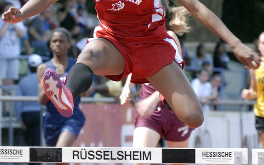 Kaiserslautern sophomore Ashley Santos clears the final hurdle en route to a first-place finish in the girls 300 meter hurdles at the 2011 DODDS-Europe Track and Field Championships in Russelsheim, Germany.   Santos finished with a time of 48.60 seconds.