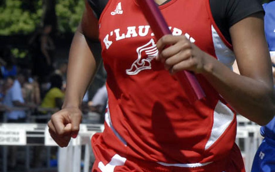 Kaiserslautern sophomore Ashley Santos holds off Ramstein junior Anna Priddy during the girls 4x800 meter relay on day two of  the 2011 DODDS-Europe Track and Field Championships.  The Kaiserlautern team of senior Colleen Davis, senior Ruby Plummer, senior Rio Harris and Santos broke a DODDS-Europe record in the event with a time of 9 minutes, 55.02 seconds.