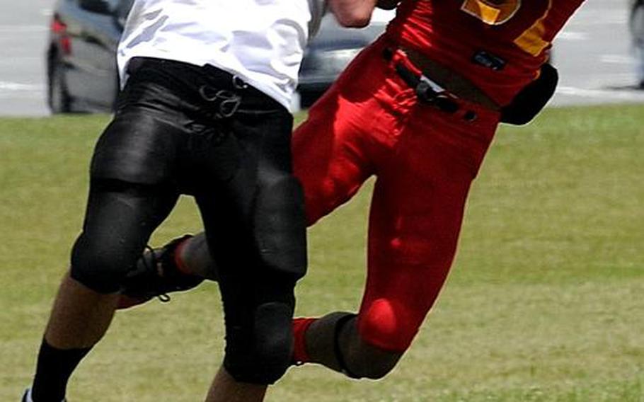 Kadena Dragons cornerback Brett Combs, left, and Foster Bulldogs receiver Roger Veal battle for the football during Saturday's U.S. Forces Japan-American Football League South Division game at Camp Foster, Okinawa. Foster won 30-14 and took a 11/2-game lead in the division over Kadena and Joint Task Force, each 0-1.