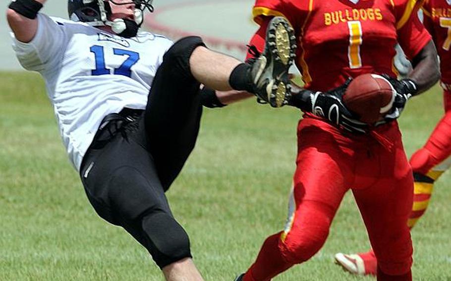 Foster Bulldogs defensive back Luke Hicks comes down with an interception of a pass intended for Kadena Dragons' Nicholas Warden during Saturday's U.S. Forces Japan-American Football League South Division game at Camp Foster, Okinawa. Foster won 30-14 and took a 11/2-game lead in the division over Kadena and Joint Task Force, each 0-1.