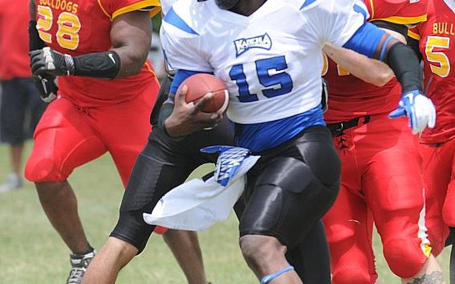 Kadena Dragons backup quarterback Kelvin Lewis skirts left end and avoids the tackle of Foster Bulldogs defenders Royce Platt, left, Will Good and Antonio Hardy, right, during Saturday's U.S. Forces Japan-American Football League South Division game at Camp Foster, Okinawa. Foster won 30-14 and took a 11/2-game lead in the division over Kadena and Joint Task Force, each 0-1. Lewis quarterbacked for Zama American High School in 2001.