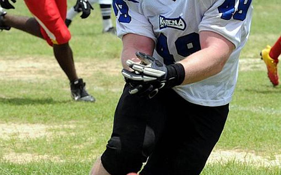 Kadena Dragons fullback Curtis Conrad can't find the handle on the football against the Foster Bulldogs during Saturday's U.S. Forces Japan-American Football League South Division game at Camp Foster, Okinawa. Foster won 30-14 and took a 11/2-game lead in the division over Kadena and Joint Task Force, each 0-1.